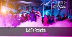 In the midst of a swirling kaleidoscope of vibrant lights and mysterious fog, the dynamic duo sways gracefully at an event commemorating 35 epic years. At the forefront stands a majestic banner: Black Tie Productions: Disc Jockey, Photo Booth, Up-Lighting. With superheroic flair and unwavering dedication, these Event Heroes bring their legendary spirit to life—offering photo booth rentals and instantaneous price quotes for an experience smoother than any dance floor youve ever set foot on. :The Event Heroes at Black Tie Productions