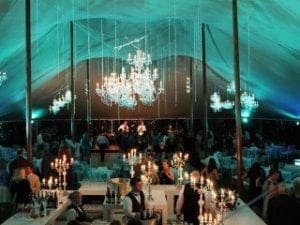 Under the glow of celestial chandeliers, a grand marquee hosts an assembly of dignified guests seated at noble tables. The gleam of glass bottles behind the bar casts a shimmering foreground that completes this formal events aura of sophistication. Fear not, for Black Tie Productions swoops in with unparalleled prowess to provide instant price quotes for their extraordinary services—such as their photo booth rentals—that promise to elevate your elegant gathering to legendary heights!. :The Event Heroes at Black Tie Productions