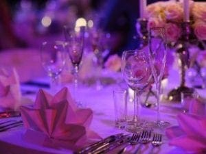 In the grand theater of unforgettable occasions, Event Heroes swoop in with their superpower of style! Behold an elegant dining tableau where folded napkins stand like sentinels, glassware gleams with a hero’s shine, and cutlery is poised like Excalibur. Floral centerpieces burst forth in vibrant glory under the mystical glow of purple lighting. Enhance your event experience as our meticulous attention to detail crafts a captivating ambiance that transforms ordinary gatherings into legendary events!. :The Event Heroes at Black Tie Productions