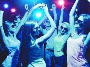 Under the blaze of vibrant blue and pink lights, a dynamic scene unfolds as partygoers donning heroic sunglasses transform the floor into their own Fortress of Cool. Their moves crackle with electrifying energy, infusing the atmosphere with a pulse that echoes through the night like an unstoppable force of celebration. :The Event Heroes at Black Tie Productions