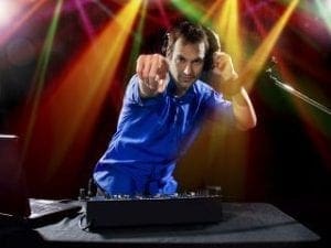 In the heart of the celebration, beneath a cascade of vibrant lights, stands DJ Sonic Boom—a musical superhero clad in his signature blue armor. With one finger pointed defiantly toward the crowd, he orchestrates a symphony of sound on his high-tech gear. This Michigan maestro doesn’t just play music; he summons an electrifying force that transforms every event into an unforgettable legend!. :The Event Heroes at Black Tie Productions