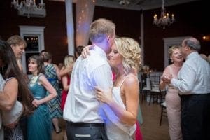 In a realm of elegance and enchantment, where grandeur reigns supreme, noble couples swirl in close harmony amidst an epic gala setting. Within this majestic hall adorned with shimmering chandeliers, artisan-crafted to rival the stars themselves, the very atmosphere comes alive. A symphony of spectacular illuminations casts their radiant warmth across this jubilant gathering—a testament to celebration as vibrant as any superheros triumph. Here, happiness is the hero of the evening!. :The Event Heroes at Black Tie Productions