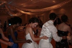 Under the shadowy canopy of night, where elegance takes flight, a league of noble guests assembles. Clad in formal armor that gleams beneath the starlit drapery, they move with the grace of heroes united. The event hall pulses with an aura scripted by masterful illumination, casting a spell of timeless sophistication upon this audacious gathering. Together, they dance as one—a testament to grandeur and unity on this unforgettable evening. :The Event Heroes at Black Tie Productions