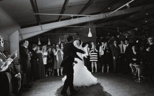 In the heart of a grand hall, where light cascades like starlight from above, the bride and groom move with the elegance of heroes on a sacred mission. Gracefully, they command the dance floor, their every step illuminated by an ethereal glow. Villains beware—this is their day! Guests stand in awe, capturing each enchanting moment as if it were a token of power. Nearby, the maestro of melodies—the Michigan DJ—stands vigilant at his sonic command center. With an orchestration that only Event Heroes could surpass, he weaves together harmonies potent enough to turn ordinary moments into legendary memories. This wedding isn’t just an event; it’s a dazzling epic where love reigns supreme!. :The Event Heroes at Black Tie Productions