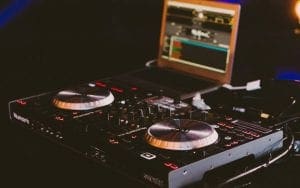 In the shadowy recesses of a secret lair, an arsenal of DJ equipment stands ready for action. A sleek Numark controller gleams with power beside a laptop loaded with cutting-edge music software, pulsating like a beacon of rhythm in the dim light. This formidable duo is the ultimate weapon for Black Tie Productions, ensuring every Michigan wedding is transformed into an epic celebration that echoes through time. With elegance and precision, they set the stage for legendary performances that mesmerize all who dare to dance along their sonic adventure. :The Event Heroes at Black Tie Productions