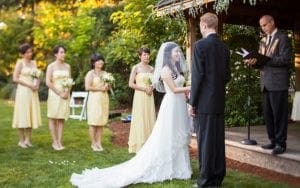 In the grand tapestry of love, beneath the watchful gaze of nature herself, stand a valiant duo—the bride and groom—united in their quest for eternal partnership. Basking in the golden glow of destiny, bridesmaids clad in radiant yellow wield bouquets as symbols of blooming support. Behind this epic moment, Event Heroes orchestrate with unparalleled precision, shaping every detail into perfection on this monumental day. :The Event Heroes at Black Tie Productions