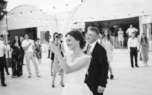 In a celebration worthy of legends, the Bride and Groom exude radiant smiles and applause, gracefully gliding among their guests beneath the celestial canopy of twinkling string lights. Fueled by the masterful mixes of Michigans finest wedding DJ, the outdoor dance floor pulses with electric joy, crafting an unforgettable aura that transforms their special day into a timeless adventure. :The Event Heroes at Black Tie Productions