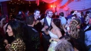 In a cavern of celebration, where elegance meets revelry, the dance floor pulsed with energy as partygoers, clad in their finest garb, moved effortlessly beneath the shimmering cloak of multicolored lights. The atmosphere crackled with excitement as the Wedding Maestro from Michigan spun beats that resonated like a sonic superpower. Meanwhile, stationed nearby was the legendary Snapshot Sentinel—a photo booth imbued with the ability to capture timeless memories—in action to commemorate each heroic moment of joy and unity. :The Event Heroes at Black Tie Productions