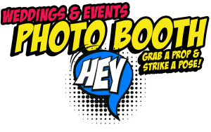 In vibrant yellow and red, the banner exclaims: Weddings & Events Photo Booth! Below, in heroic style: Grab a prop & strike a pose! appears alongside a bold blue speech bubble. Perfect for any Michigan wedding DJ event, this photo booth rental is your ticket to supercharged fun and unforgettable memories. Get an instant price quote today and let the adventure begin!. :The Event Heroes at Black Tie Productions