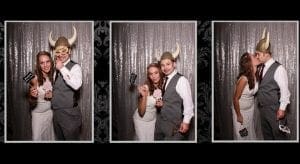 In the realm of celebration, where elegance meets whimsy, a dynamic duo steps into the legendary photo booth—a portal of endless possibilities. Dressed in their finest ceremonial garb, they transform with heroic flair, donning artifacts of amusement: a mighty Viking helmet and a mask that conceals their true identities. Armed with miniature chalkboard signs as their superpowered tools of expression, they lean in for an electrifying kiss captured in the third triumphant frame. This is no mere collection of images; it is a chronicle of valor and romance etched forever in time! For those who seek to immortalize their own epic moments, this service offers event lighting worthy of spotlighting greatness and an instant price quote—for heroes require swift decisions!. :The Event Heroes at Black Tie Productions