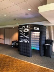 Unleash the power of fun with our epic Inflatable Photo Booth Rental! Equipped with iconic Photo Booth and Exit signs, this indoor adventure zone is designed for your convenience. Gear up with a galaxy of exciting props from a nearby table, and transform your memories into legendary moments. Contact the extraordinary Black Tie Productions now for an instant price quote that will elevate your party to superhero status!. :The Event Heroes at Black Tie Productions