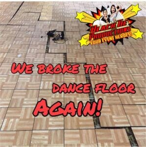 In a world where rhythm reigns supreme and nights are legendary, behold the scene: a battle-worn wooden dance floor, its sections awry like pieces from an epic clash. Above it floats a vibrant proclamation: We shattered the dance floor AGAIN! In the sky, high to the right, our emblem shines like a beacon of justice. For those who dare keep this party in perfect harmony and immortalize each heroic moment, summon the Michigan wedding DJ or enlist the photo booth sentinel—they are your guardians of groove!. :The Event Heroes at Black Tie Productions