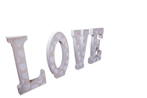 Black Tie Productions: The image features 3D block letters spelling LOVE against a transparent background, perfect for a wedding photo booth. The beige letters with white heart patterns are arranged at an angle, creating depth and slightly reflective surfaces that enhance their texture. :Your Event Heroes
