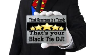 In a sleek suit, a figure stands tall, revealing beneath their shirt the iconic emblem of Superman. The card they hold proclaims: Picture Superman in a Tuxedo—Behold your Black Tie DJ! With stars illuminating the message, prepare to encounter the sophistication of Black Tie Productions. As your Event Heroes, they wield their powers to transform any gathering into an extraordinary celebration worthy of legends. :The Event Heroes at Black Tie Productions