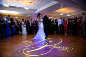 In the grand ballroom, where heroes unite to celebrate loves triumphant tale, the bride and groom take center stage for their first dance. The Michigan DJ, wielding the power of rhythm and melody, orchestrates a symphony of emotions that fills the air with enchantment. Encircled by their loyal guests and allies, they twirl in perfect harmony as beams of light etch their names onto the wooden floor—a radiant emblem of their union destined for greatness. :The Event Heroes at Black Tie Productions