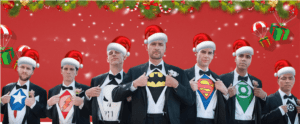 In a dazzling display of heroism and holiday cheer, seven noble men stand side by side, each clad in classic tuxedos concealing their true identities: beneath their jackets gleam the iconic shirts of superheroes. Adorned with Santa hats perched confidently atop their heads, they create a festive tableau against a vibrant red backdrop, bursting with Christmas decorations. The event lighting shines brilliantly, casting an electrifying glow that highlights the merry marvel of this joyous gathering. Each man embodies the spirit of heroism and holiday magic, ready to uplift and inspire all who witness their festive formation. :The Event Heroes at Black Tie Productions
