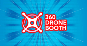 Behold, the legendary logo: 360 Drone Booth emblazoned in bold red letters against a vibrant blue backdrop, intersected by dynamic white dashed lines that pulse with energy. At its heart, a powerful circular drone emblem soars—a symbol of adventure and innovation. This emblem stands ready to elevate your photo booth rental service to heroic heights!. :The Event Heroes at Black Tie Productions